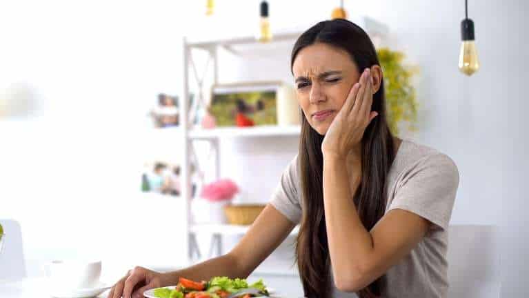 A woman experiencing a dental emergency