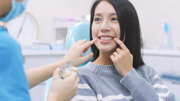 A smiling woman receiving a dental exam